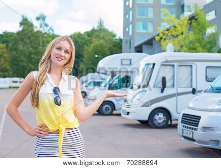 Beautiful Young Woman Offers Campervans At Shop.