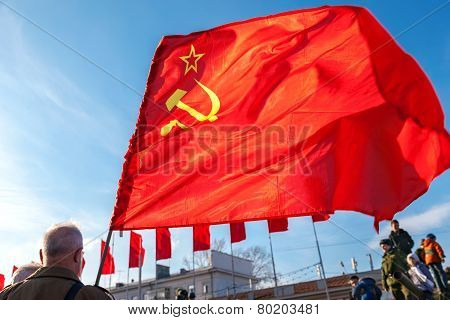 Red Flag Waving Over Blue Sky Background At The Kuibyshev Square In Samara, Russia