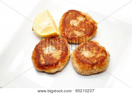Fried Salmon Cakes With A Wedge Of Lemon