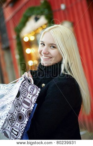 Lovely girl with shopping bags on the street
