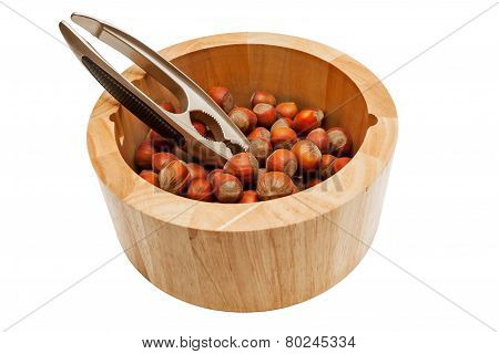 Hazelnuts in bowl isolated on white background