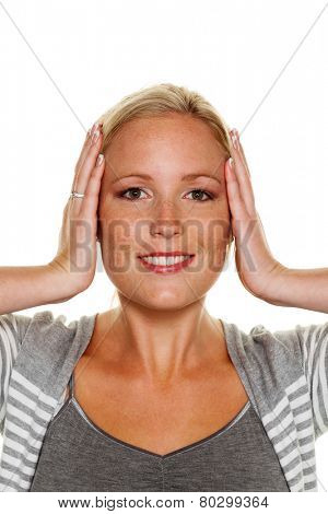 a young woman holds her ears. symbolic photo for not want to hear disputes and conflicts, as well as loud undtinnitus