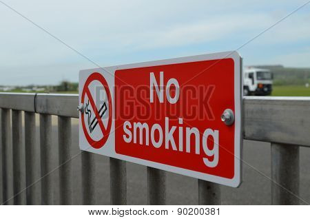 No smoking sign beside airport runway