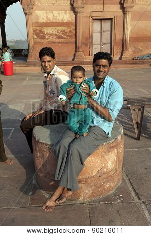 Father With His Children Rests On Courtyard Of Jama Masjid Mosque In Delhi