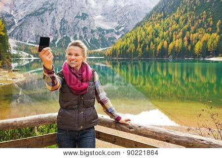 Woman Hiker Taking A Selfie At Lake Bries With Autumn Colours
