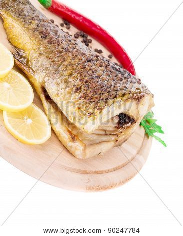 Fried carp tail with lemon and pepper.
