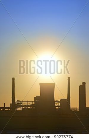 Silhouette Of Industrial Factory At Sunset