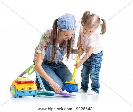 Child girl and mother sweep floor