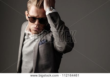 Confident sharp dressed man in grey suit 