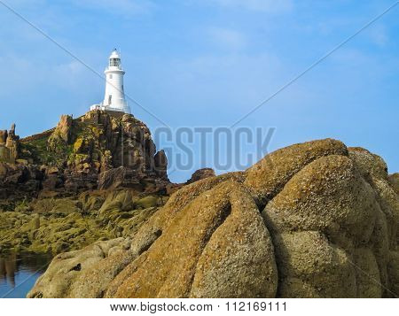 Lighthouse on the rocky coast of Jersey Island