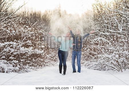 Young Beautiful Couple Walking In Winter Forest