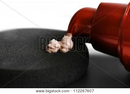 Makeup sponge with liquid foundation, close up