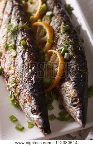 Saury Grilled With Lemon On A Plate Macro. Vertical Top View