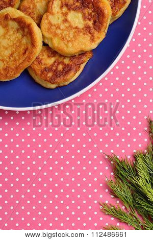 potato pancakes and dill on a red background with polka dots