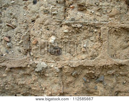 Wall Of Mud Bricks With Some Little Stones And Straw And Concrete Bricks
