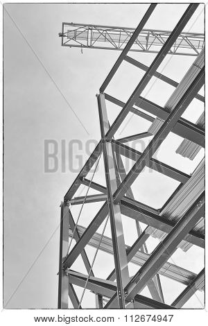 A Construction Site With Steel Framing And A Yellow Construction Crane