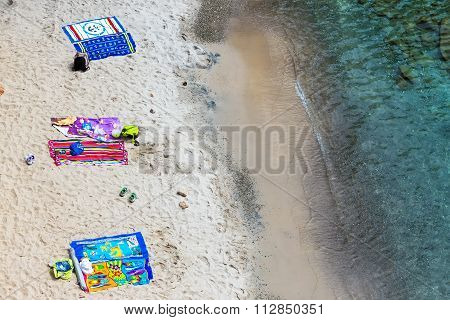 Top View Of Towels At Tsigrado Beach In Milos Island, Cyclades, Greece