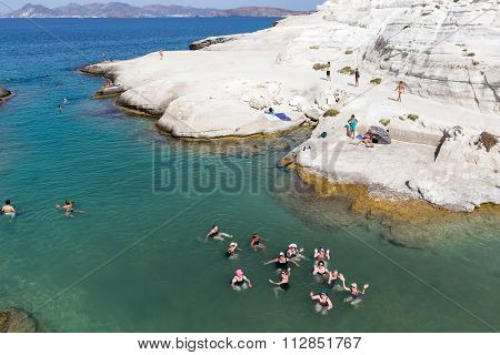 Tourists Enjoy The Clear Water Of Sarakiniko Beach In Milos, Greece. This Beach Is One Of The Most B