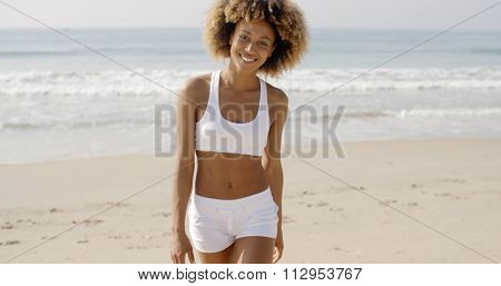 African american woman in sportswear going away from sea in slow motion