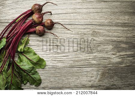Fresh organic beetroot on wooden background. Healthy concept.