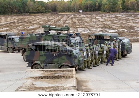 MUNSTER / GERMANY - OCTOBER 9 2017: german military police soldiers defends an area against role playing demonstrators