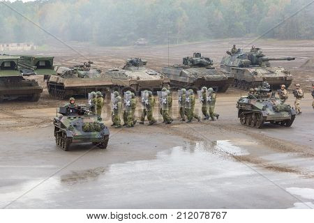 MUNSTER / GERMANY - OCTOBER 9 2017: german military police soldiers defends an area against role playing demonstrators