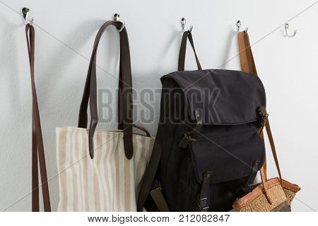 Close-up of various bags hanging on hook