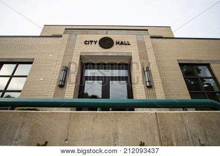 Petoskey, Michigan, USA - October 2, 2017: Exterior of the Petoskey City Hall Municipal Offices with city seal above the door. Petoskey is a resort town in the Lower Peninsula of Michigan.