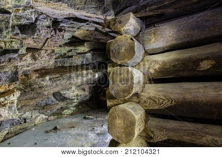 Abandoned underground old chromite mine shaft tunnel with wooden timbering