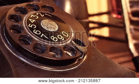 Closeup Of Black Retro Vintage Telephone With Rotary Dialer Or Dialpad. Local Vintage Telephone For