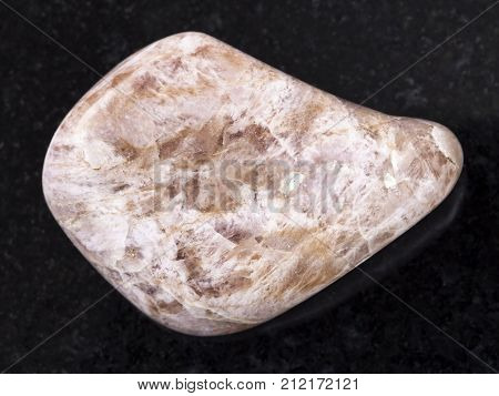 Tumbled Ussingite Gemstone On Dark Background