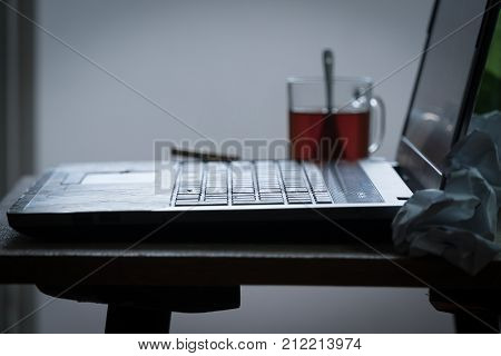 Workplace Of A Programmer Or Writer. The Laptop Is On The Table With Tea, Beer And A Cigarette