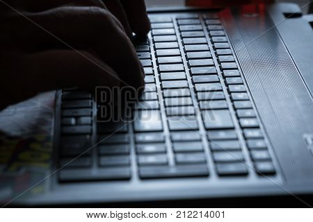 Men's Hands Are Typing On The Laptop's Keyboard