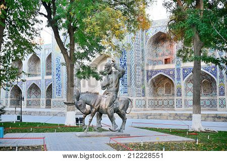 2013 November 11, Sculpture of Nasreddin Hodja against ancient mosque wall, Bukhara, Uzbekistan
