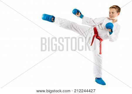 Pre-teen boy doing karate on a white background