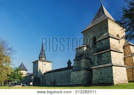 Tourists visit one of the four towers of Sucevita Monastery in village Sucevita, Suceava County, Romania. Monastery is in the World Heritage Sites by UNESCO as one of the Painted churches of Moldavia