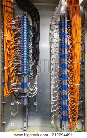 Low-voltage cabinet non-combustible cable for a fire alarm system. Connected the cable through the terminals in the mounting cabinet.