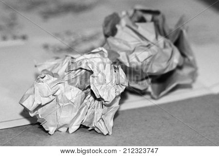 Close-up Of Crumpled Paper Balls On A White Wooden Background With Pencils And Pencil Shavings.