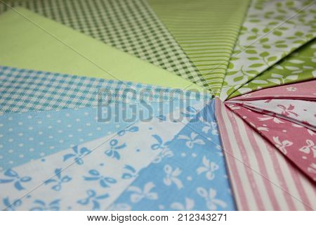 Multicolored cuts of fabric against the background of boards
