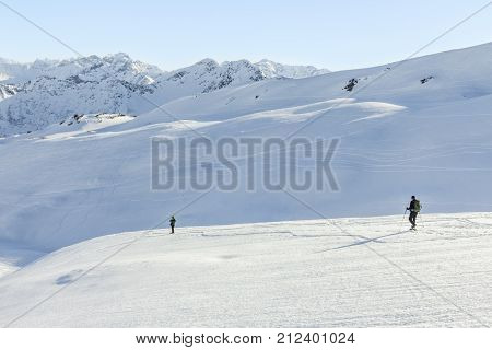 Couple hiking with snowshoes in winter mountain landscape. Alps in Germany, Bavaria, Allgau.