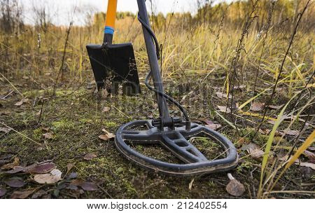 Treasure Searching With Metal Detector And Shovel On The Stubble Field