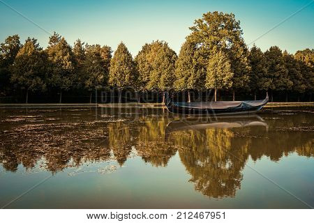 Beautiful water reflections with a boat and trees