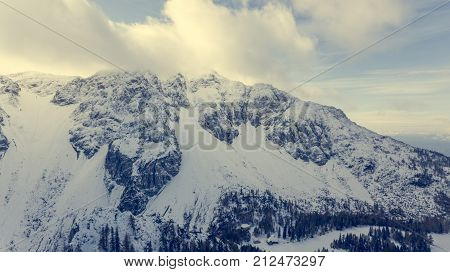 Aerial view of mountain slopes covered with early snow. Begunjscica ridge in Karavanke, Slovenia.