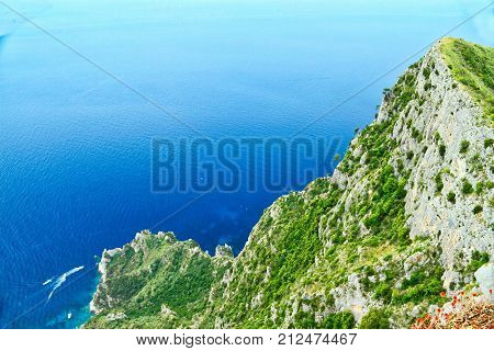 Looking at a cliff on the island of Capri with the ocean fading into the sky.