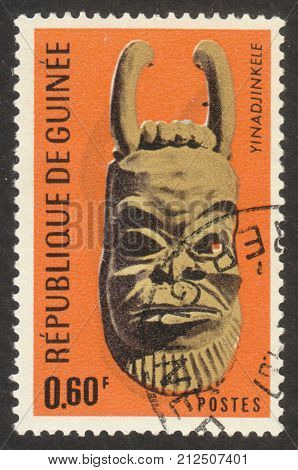 MOSCOW RUSSIA - CIRCA OCTOBER 2017: a post stamp printed in GUINEA shows a traditional mask the series 