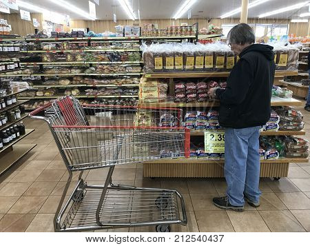 Altoona Wisconsin October 30 2017 Senior man shopping in a modern Grocery store