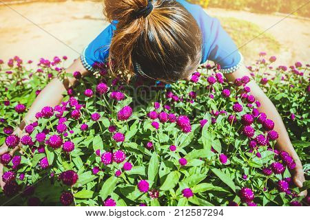 Asian women travel sleep relax. women hill tribe in the field of flowers Gomphrena globosa purple. Thailand