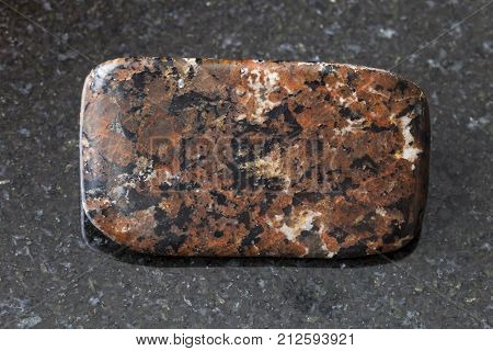 Tumbled Spreusteined Urtite Stone On Dark
