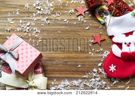 Christmas background with decorations and gift boxes on wooden board flat lay copy space