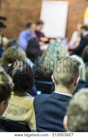 Mediation at The Round Table.Group of Young Professional Mediators Having a Public Discussion at the Round Table on Stage Before the Audience. Vertical Image Composition